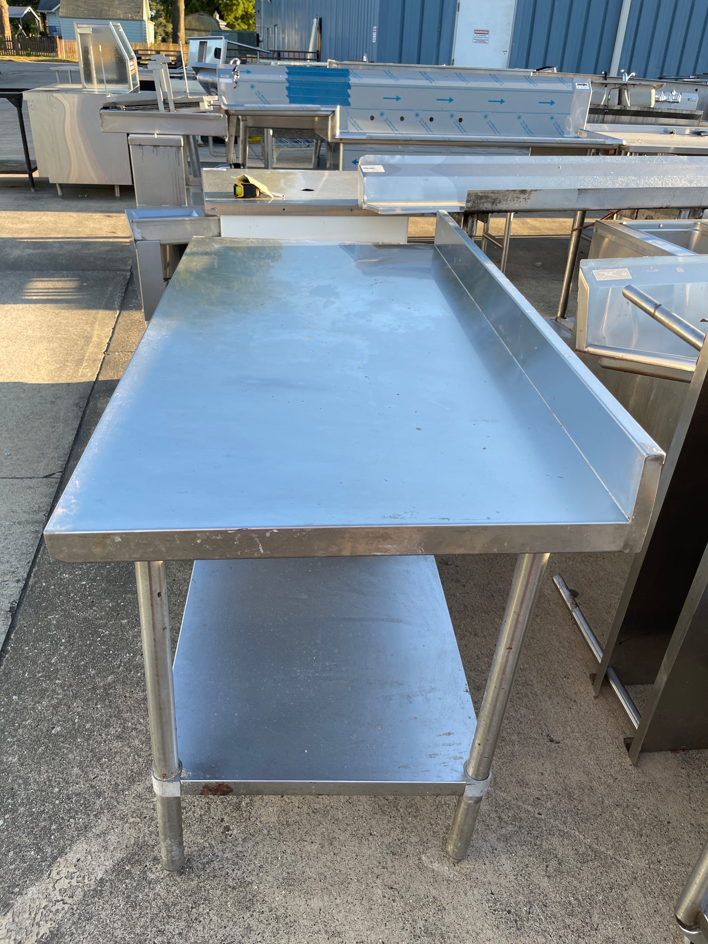 Used Regency 30"X60" Stainless Steel Table with Shelf and 4" Backsplash JD - SS322