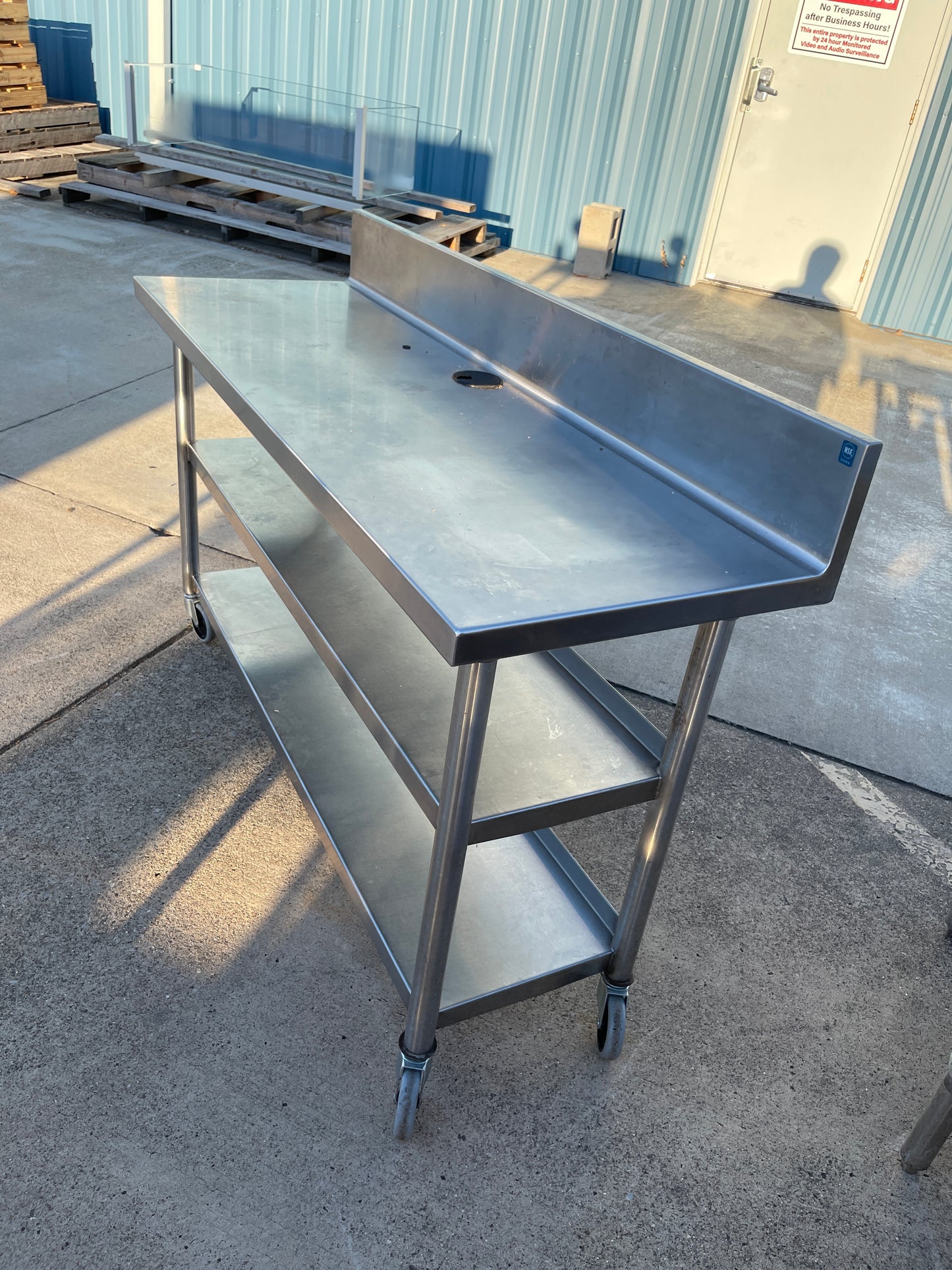 Used 60"x20" Heavy Stainless Table with Shelves, Casters and 6" Backsplash JD - SS323