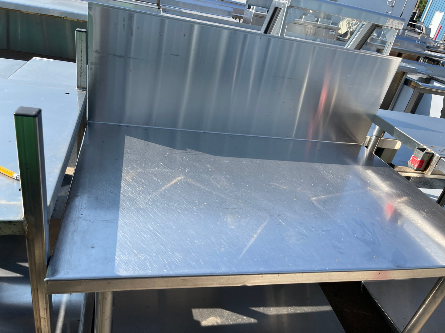 Used 48" Stainless Steel Table with a 16" Backsplash and Caster Wheels - SS114
