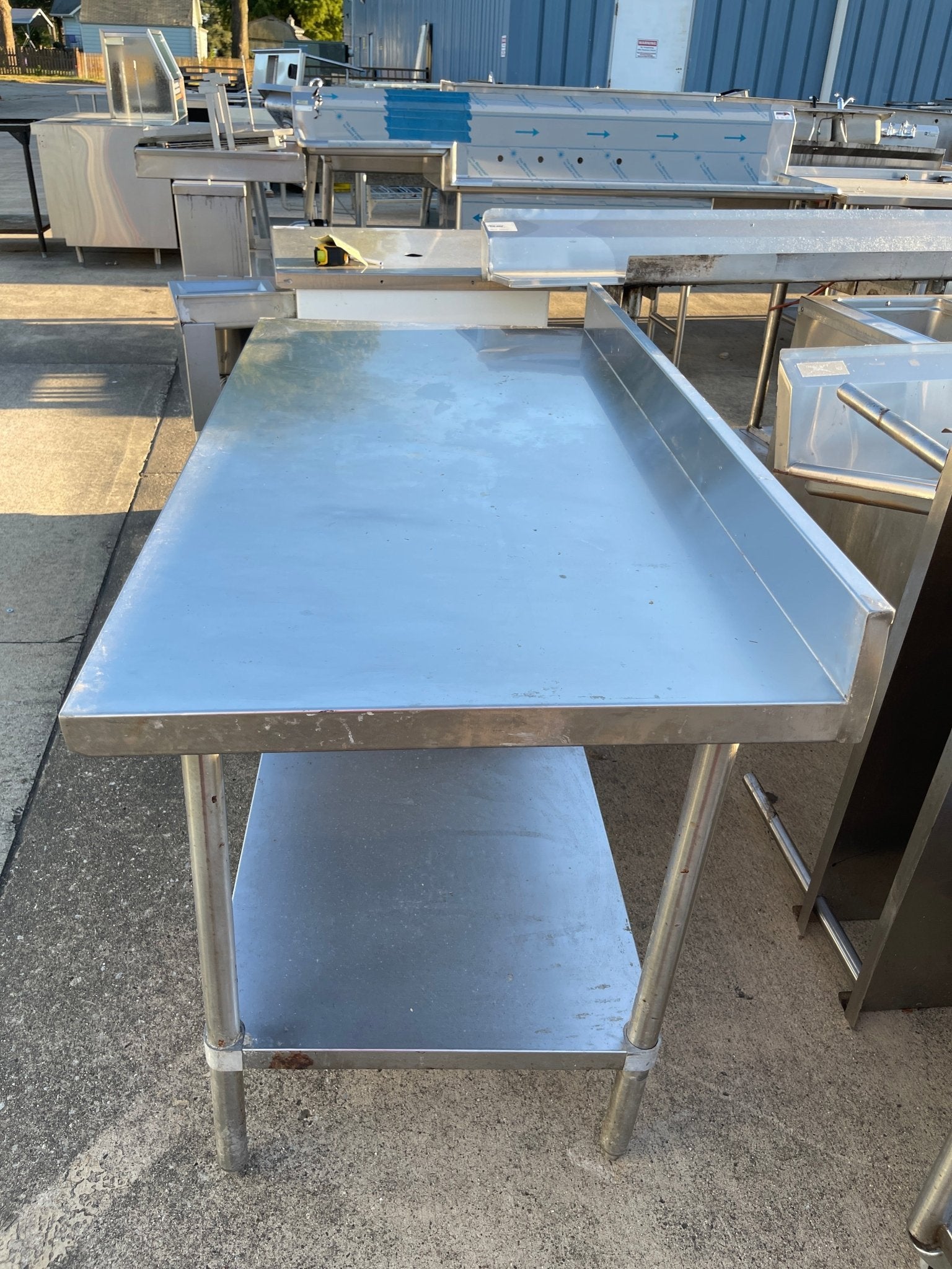 Used Regency 30"X60" Stainless Steel Table with Shelf and 4" Backsplash JD - SS322 - Falcon Restaurant Supply - 2
