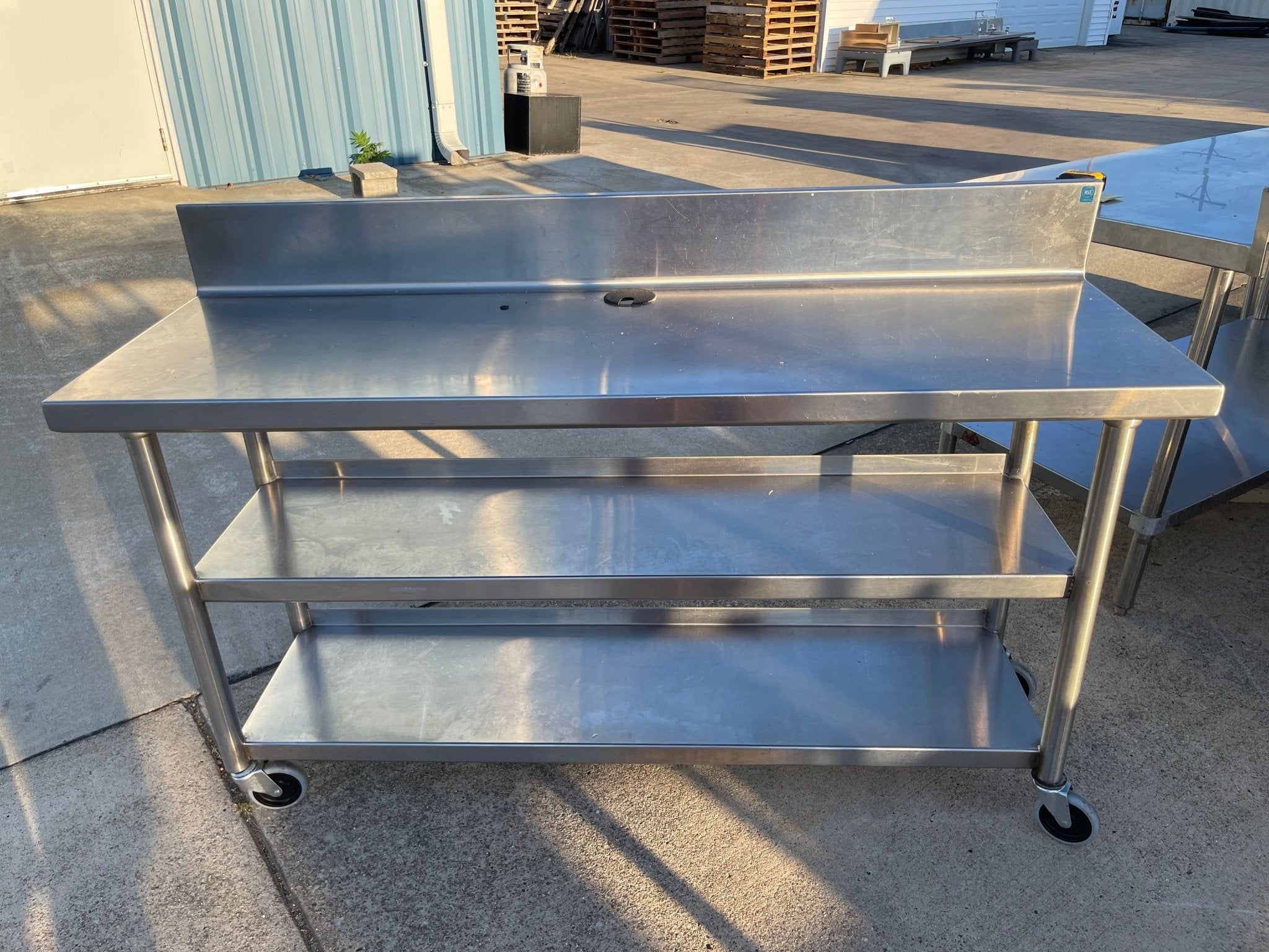 Used 60"x20" Heavy Stainless Table with Shelves, Casters and 6" Backsplash JD - SS323 - Falcon Restaurant Supply - 1