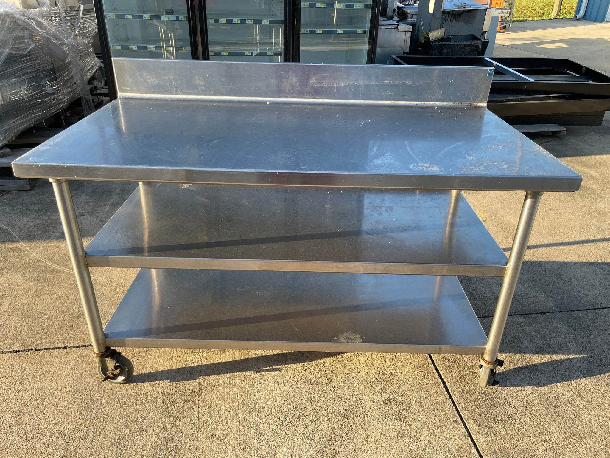 Used 60"x32" Heavy Stainless Table with Shelves, Casters and 6" Backsplash JD - SS325 - Falcon Restaurant Supply - 1