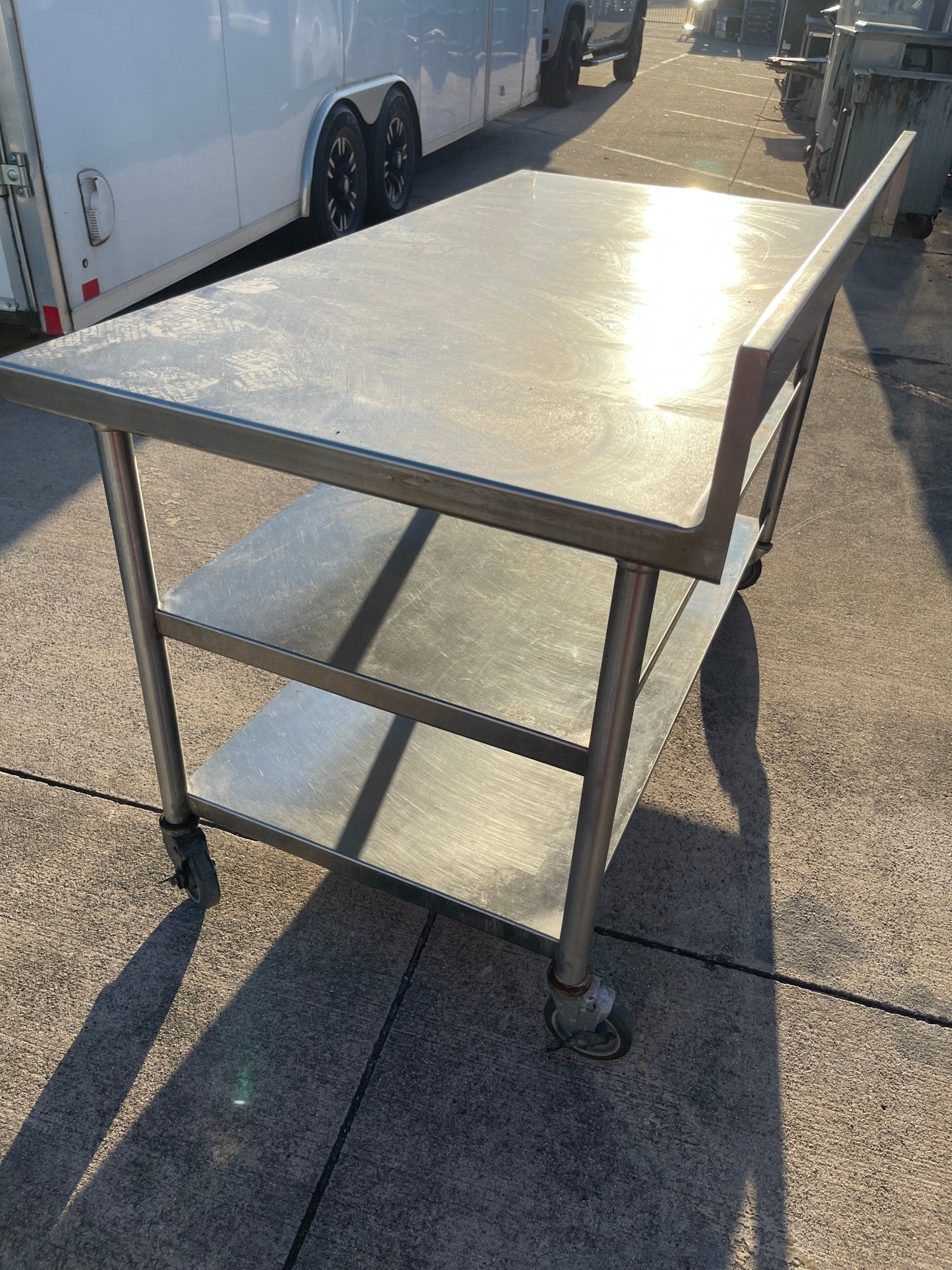 Used 60"x32" Heavy Stainless Table with Shelves, Casters and 6" Backsplash JD - SS325 - Falcon Restaurant Supply - 3