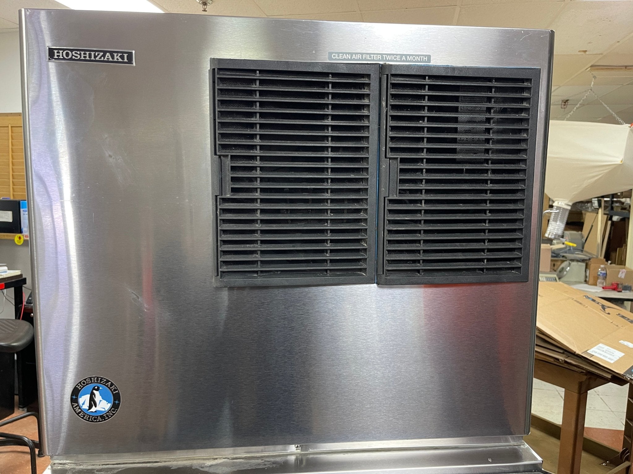 Stainless steel Hoshizaki ice machine in a warehouse setting