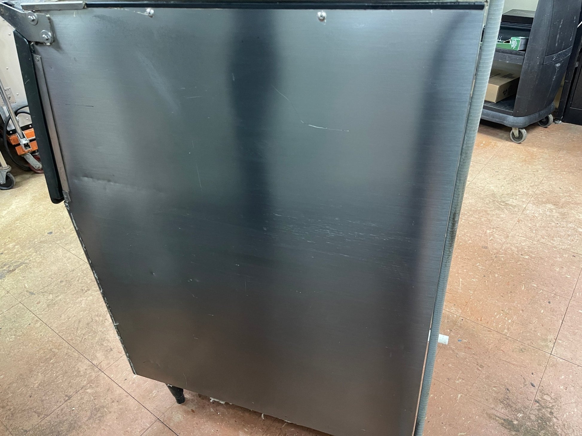 Stainless metal side panel of an ice maker
