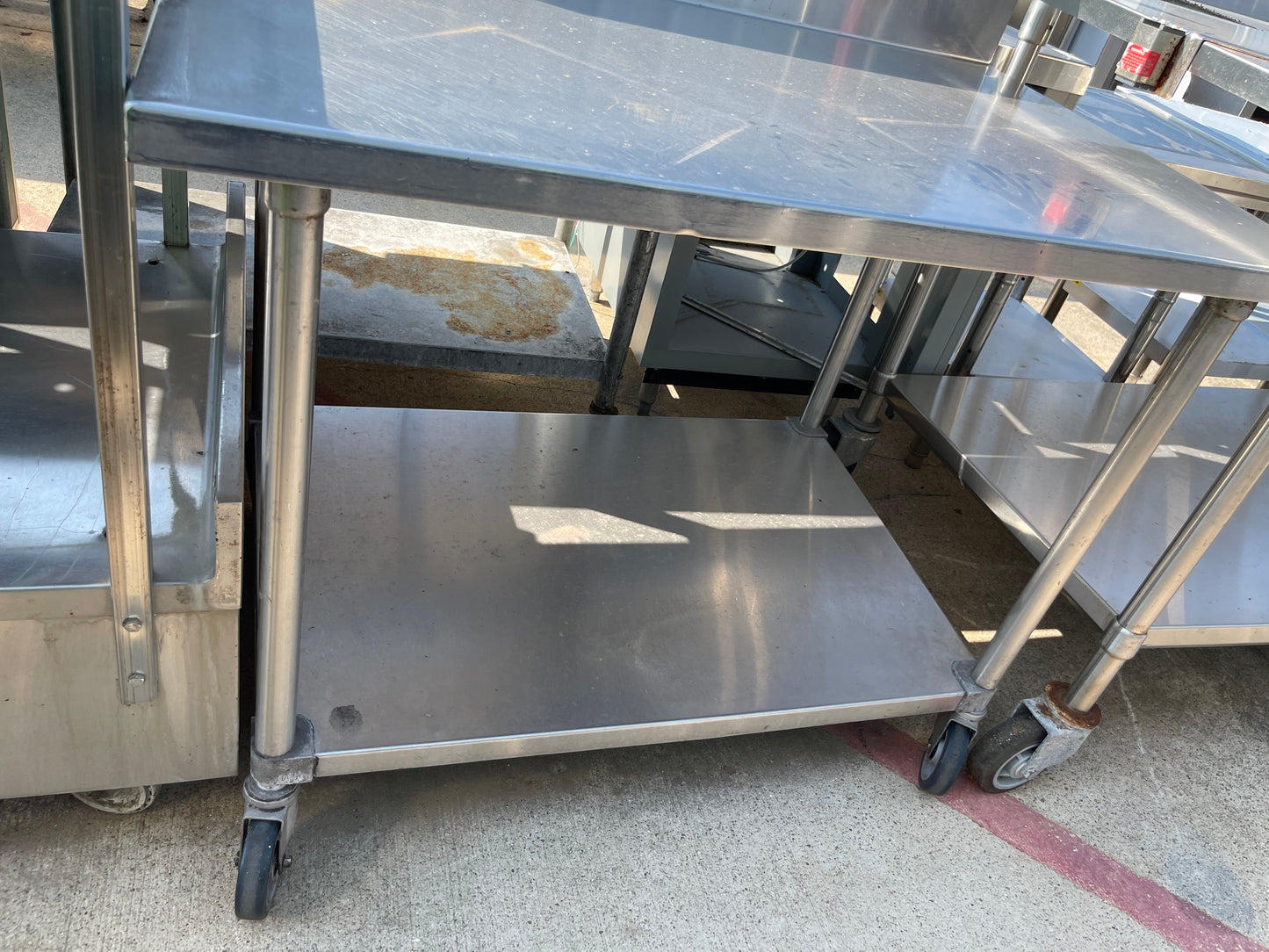 Used 48" Stainless Steel Table with a 16" Backsplash and Caster Wheels - SS114