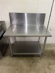 Used 48"X30" Stainless Table with 16" Backsplash on Casters - FG - Falcon Restaurant Supply - 1
