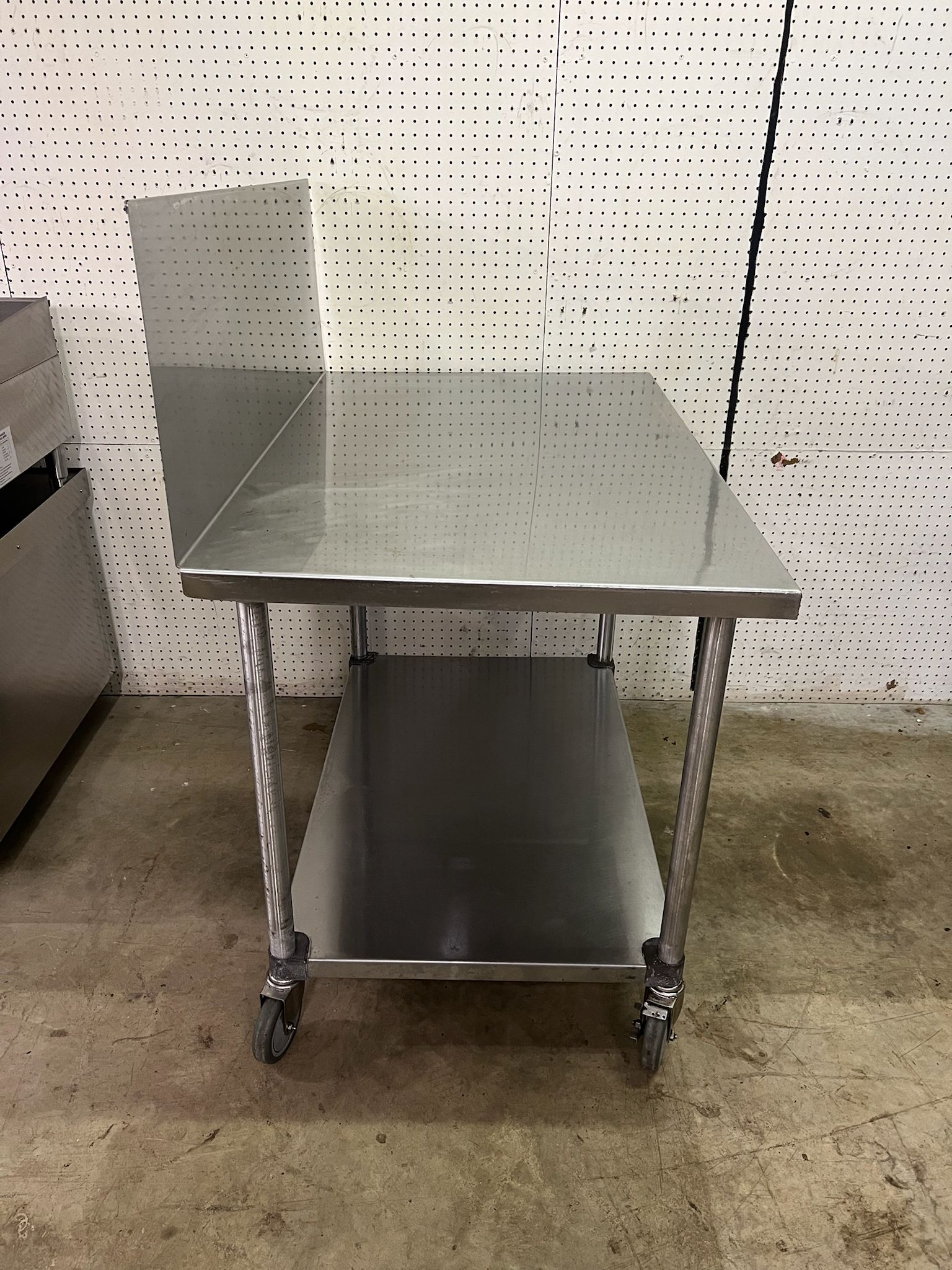 Used 48"X30" Stainless Table with 16" Backsplash on Casters - FG - Falcon Restaurant Supply - 2