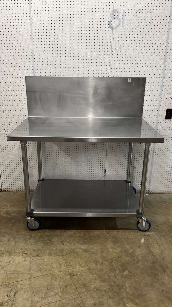 Used 48"x 30" Stainless Steel Table with Casters and a 16" Backsplash - FG