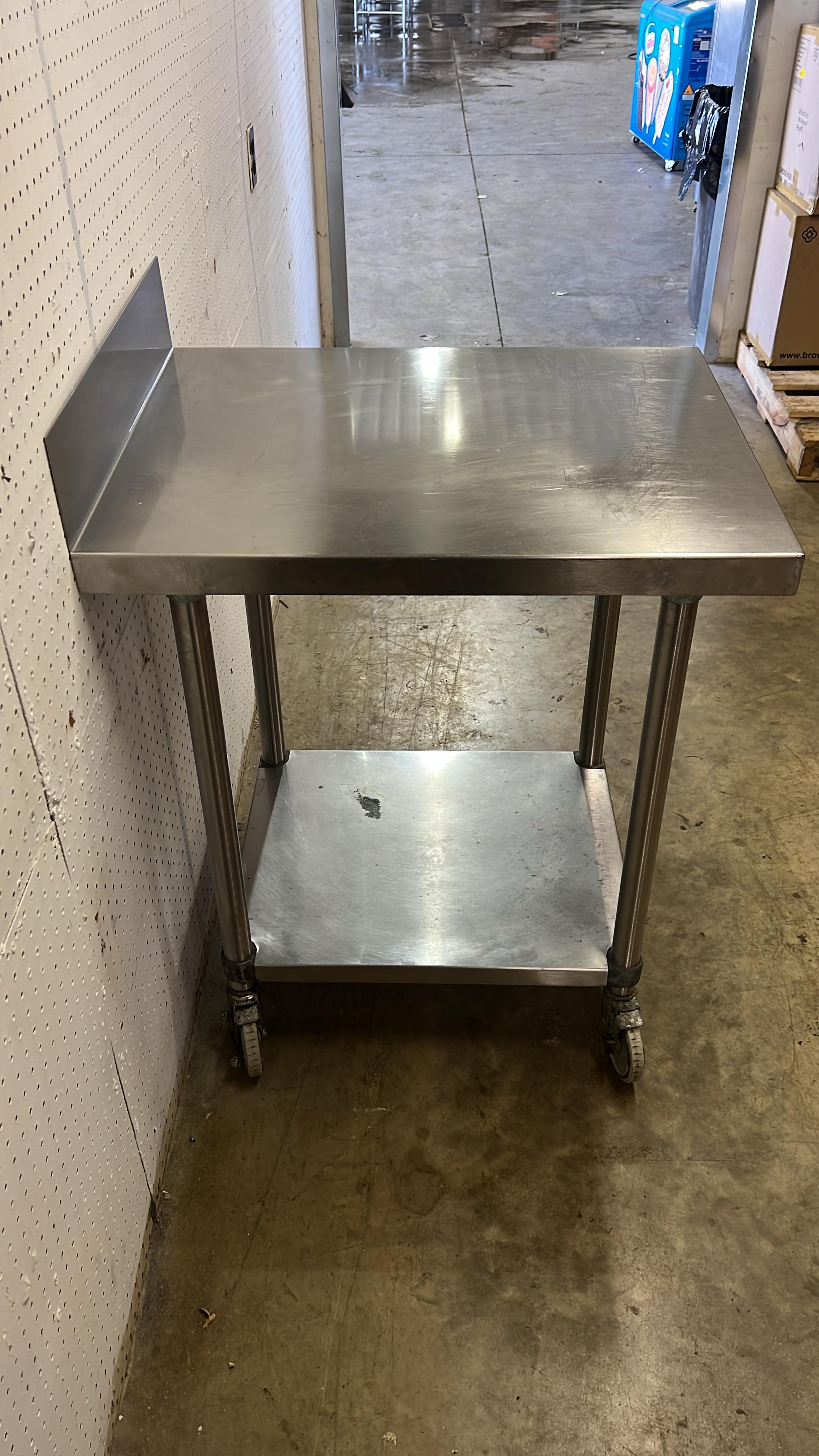 Used 24" X 30" Stainless Steel Table with Shelf and Casters