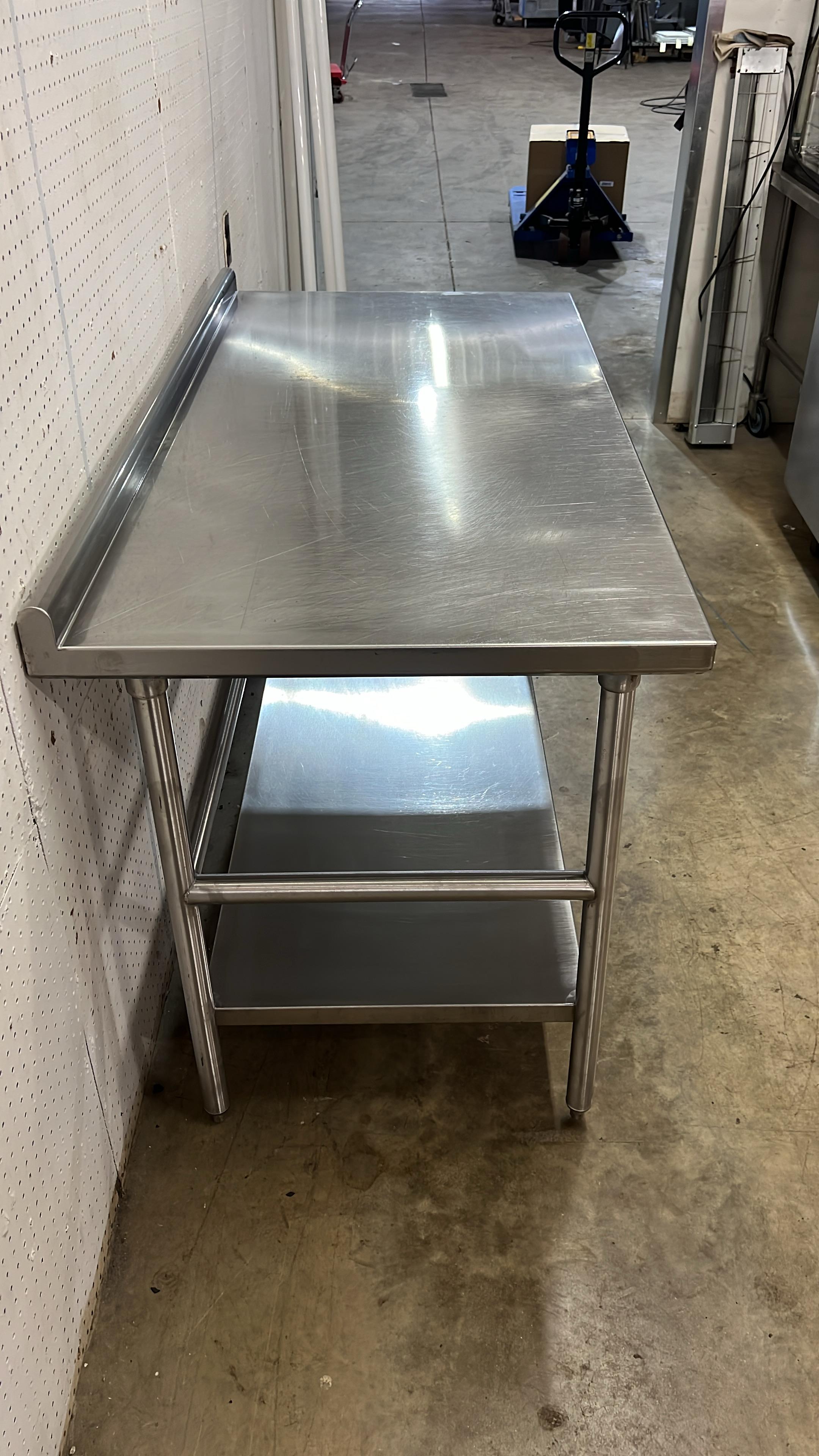 Used 60" x 30" Stainless Steel Table with 2" Back - JJ