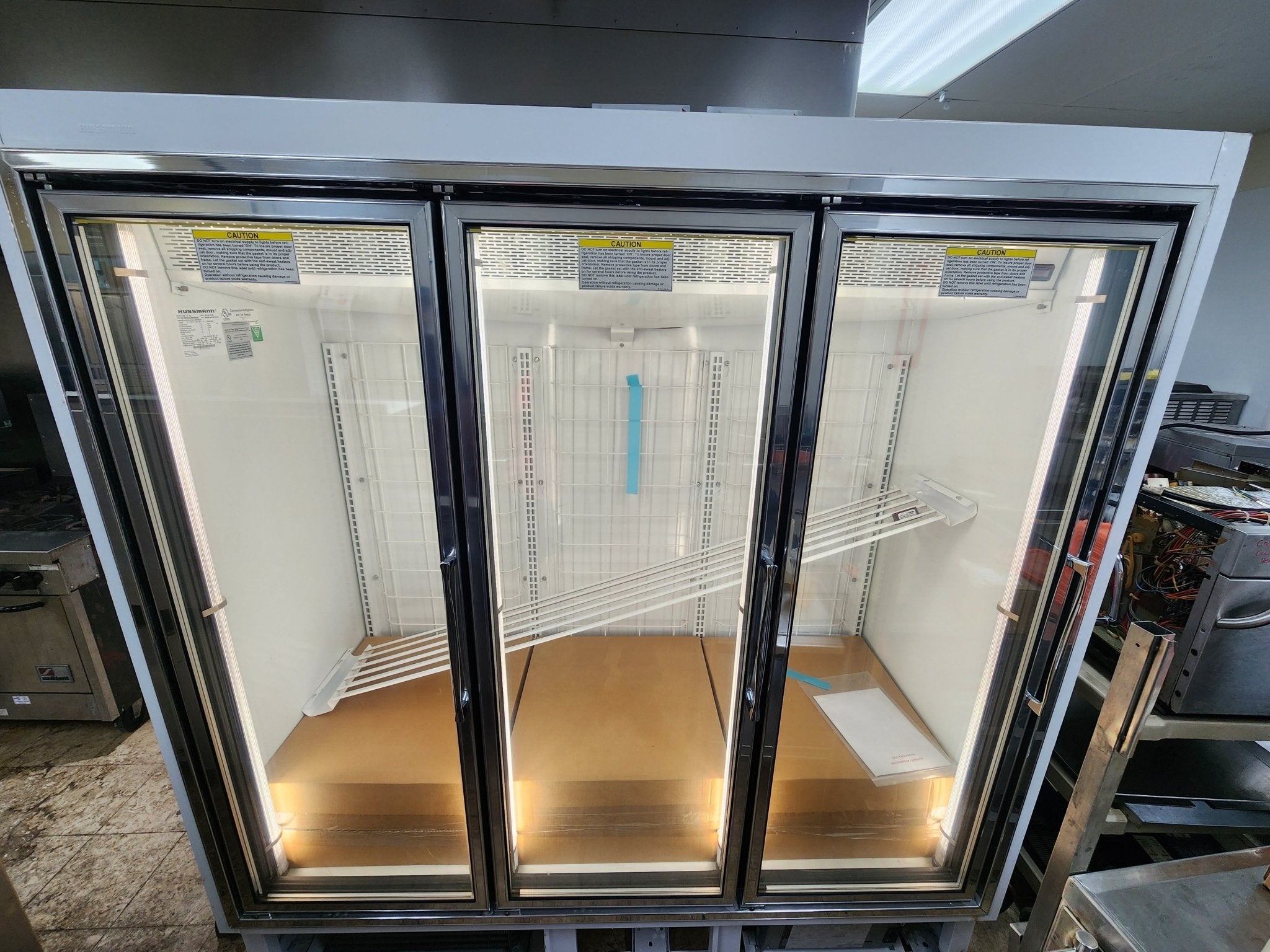 Used Hussmann HGL - 3 - BS 3 Door Reach - In Cooler Merchandising Freezer - Falcon Restaurant Supply - 1